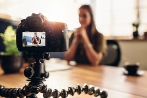 A woman makes a video blog to build an audience