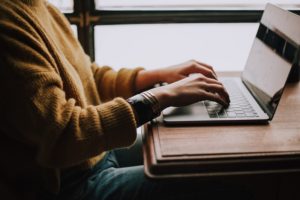 a woman writes at a cafe and becomes a better blogger